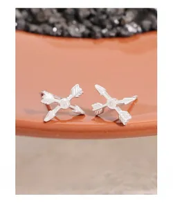 Detailed close-up of S925 sterling silver Cupid arrow stud earrings with white zircon