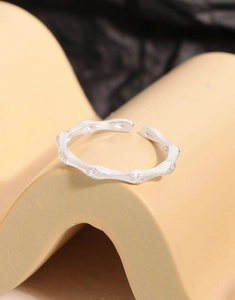 Macro shot of S925 sterling silver ring with textured organic lines and zircon inlay