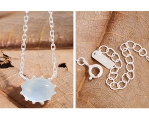 Macro detail of S925 sterling silver stamp and oval light blue gemstone pendant