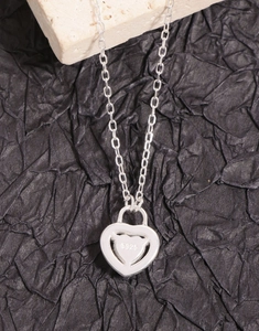Macro shot of S925 sterling silver heart lock pendant with hallmark engraving details