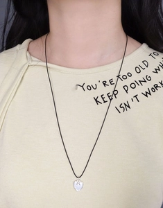 Detailed view of an adjustable black cord necklace with S925 silver heart pendant for women