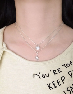 Close-up of double-layer silver S925 necklace featuring heart and star zircon pendants