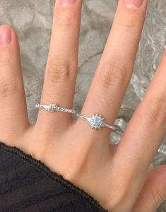 Detail of S925 sterling silver star ring with opal stone and hammered texture band