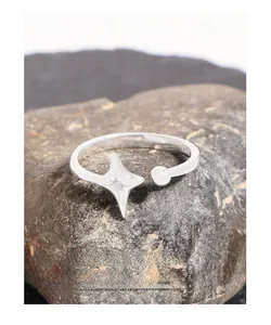 Macro detail of S925 sterling silver star ring with zircon stone on dark stone surface