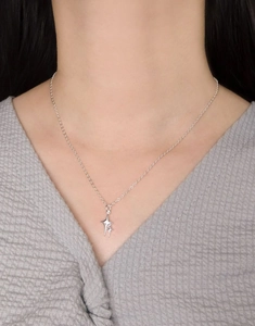 On-model shot of a 925 sterling silver star pendant necklace with zircon stones