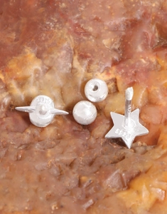 Macro detail of S925 sterling silver star screw earrings and hallmark engraving