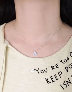 Close-up of S925 silver heart padlock necklace with sparkling zircon on a model