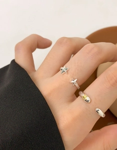 Detailed view of silver and gold star rings on fingers, adjustable S925 sterling silver set