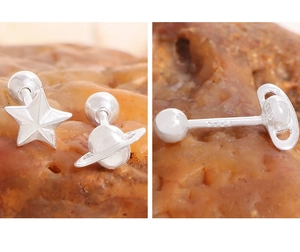 Detailed close-up of S925 sterling silver star and planet screw back earrings on a stone