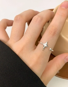Close-up of S925 sterling silver starburst ring with zircon worn on finger