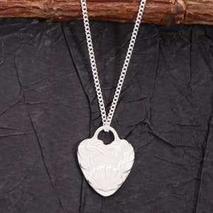 S925 sterling silver heart necklace with shell pattern relief on black background