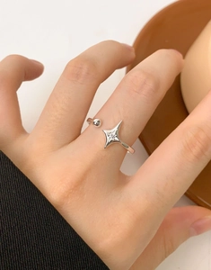 Detail of S925 sterling silver starburst ring with zircon worn on a female hand