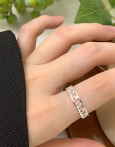 Detailed close-up of S925 sterling silver ring with hollow heart patterns on finger