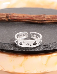 Detail of S925 sterling silver open ring featuring hollow heart and round patterns