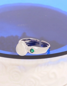 Macro detail of pear-shaped white agate ring with a small green gemstone in S925 silver