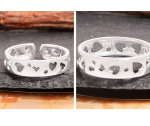 Macro detail of S925 sterling silver stamp and hollow heart pattern on adjustable ring