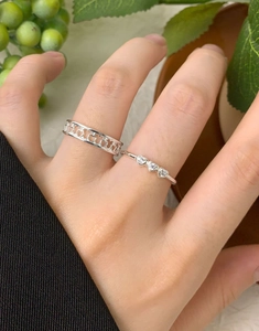Close-up of S925 silver heart rings with hollow band and sparkling zircon stones