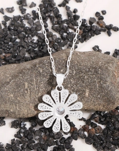 Macro shot of S925 sterling silver stamp on daisy flower pendant with zircon stones