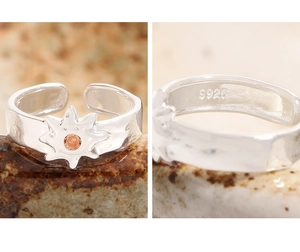 Detail view of S925 sterling silver sun ring with orange gemstone and hammer texture
