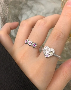 Detailed view of stacked S925 silver heart rings with colorful zircon gemstones