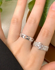 Close-up of S925 sterling silver hollow heart rings on model hand set of two