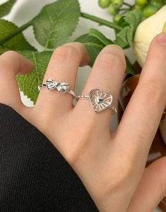 Close-up of S925 sterling silver bow and radiant heart ring set on model's hand