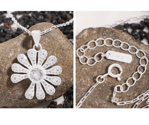Macro detail of S925 sterling silver daisy pendant necklace with sparkling zircon pavé