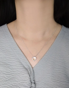 Detail of S925 silver heart necklace with moonstone pendant on a snake bone chain