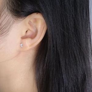 Minimalist S925 sterling silver star screw earrings on female model earlobe