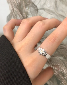 Detail of S925 silver sunburst ring with yellow zircon on a finger, sleek modern style