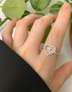 Detail of S925 sterling silver hollow heart ring with radiant lines and beaded texture