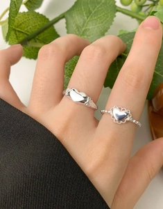 Detail of S925 sterling silver heart rings with hollow lace and smooth solid heart design