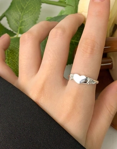Close-up of S925 silver heart ring with bow details worn on hand for a sweet aesthetic