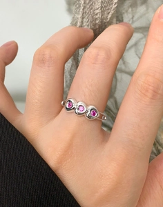 Detailed view of S925 silver ring featuring three pink round gemstones in bezel setting