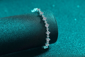 Close-up of S925 silver moissanite bracelet with brilliant round stones on a dark pedestal