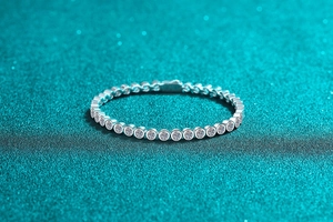 Detailed macro view of S925 sterling silver moissanite bubble bracelet on teal background