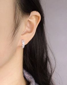 Close-up of S925 sterling silver hoop earrings with cubic zirconia stones on model