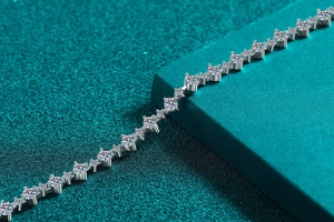 Macro shot of S925 sterling silver tennis bracelet with round moissanite in four-prong setting