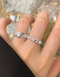 Detailed view of S925 sterling silver sun ring with yellow crystal on a marble background