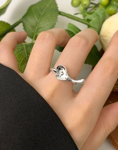 Close-up of minimalist S925 sterling silver irregular heart ring on female finger