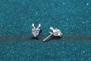 Macro view of sterling silver reindeer antler stud earrings with sparkling moissanite