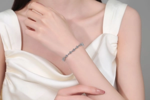 Close-up of S925 sterling silver bracelet with blue zircon on female wrist
