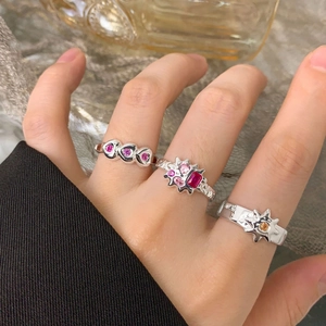 Three S925 silver rings with heart shapes and colorful gemstones on a female model