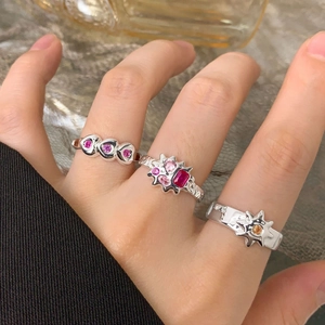 Three S925 sterling silver rings with sun, star, and heart patterns in a stylish set