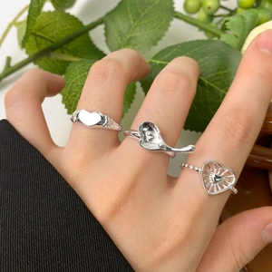 Three assorted S925 sterling silver heart rings in liquid and vintage wing styles