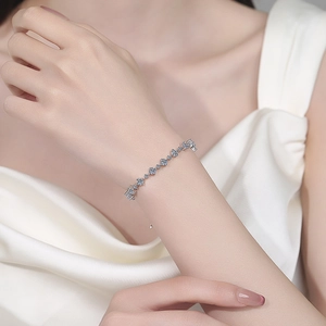 Elegant S925 sterling silver moissanite bracelet with small flower charms on wrist