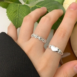 Elegant S925 sterling silver bow and heart-shaped rings set worn on a finger