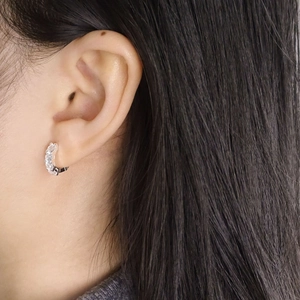 Elegant S925 sterling silver hoop earrings with shimmering cubic zirconia on model