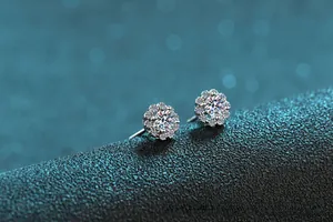 Macro shot of S925 sterling silver stud earrings with moissanite center and halo stones