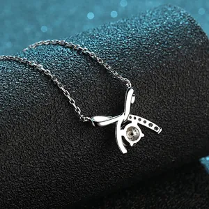 Elegant S925 sterling silver bow necklace with a sparkling four-prong moissanite pendant